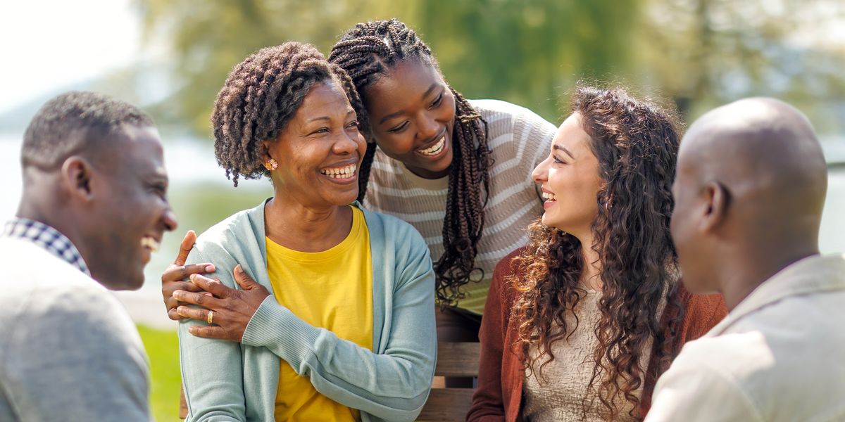 Friends of various ages joyfully spending time together at a park.