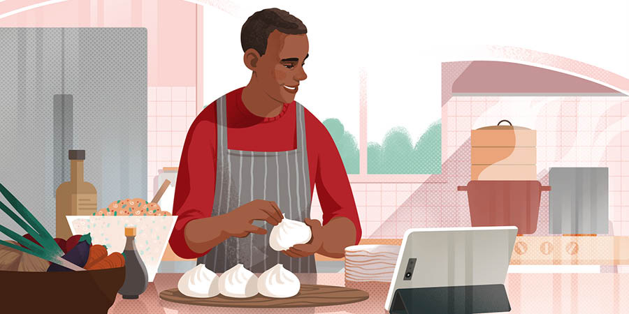 Un hombre cocina siguiendo la receta de un video.