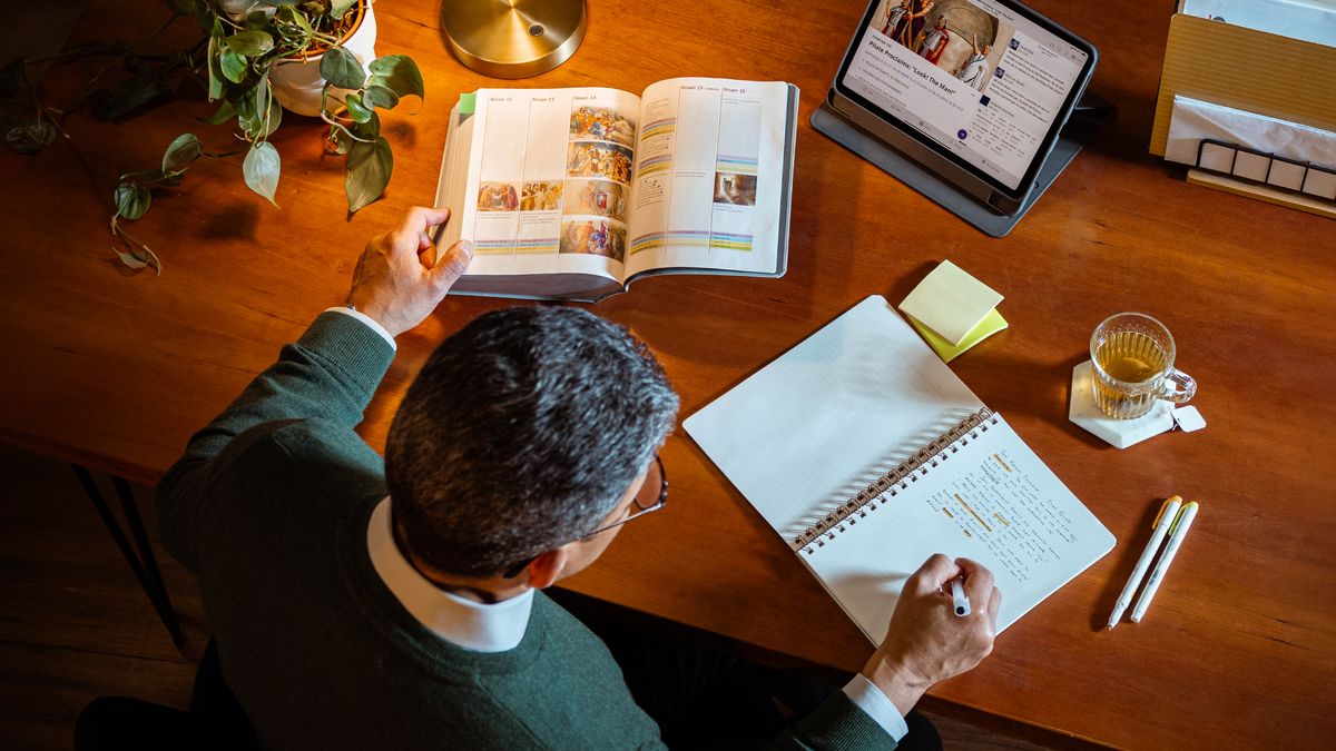 Un hermano mayor hace su estudio personal con la Biblia, una tableta y un cuaderno. Consulta la tabla “La última semana de Jesús en la tierra (Parte 2)”, que aparece en el apéndice B12-B de la “Traducción del Nuevo Mundo”. También consulta el capítulo 129 del libro “Jesús: el camino, la verdad y la vida”.