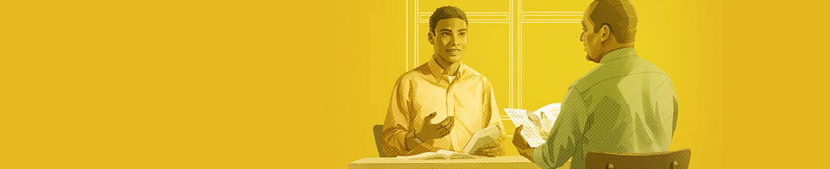 A young man studying the Bible with the help of one of Jehovah’s Witnesses.