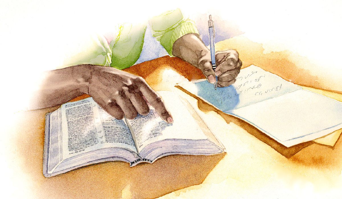 A person writes a comforting scripture in a card