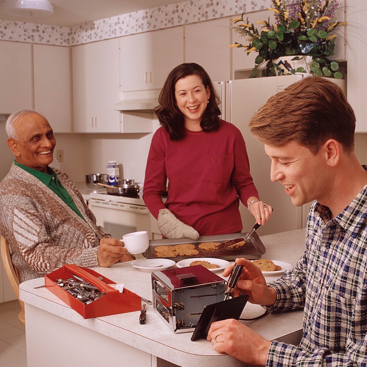 A couple helps a man with household chores