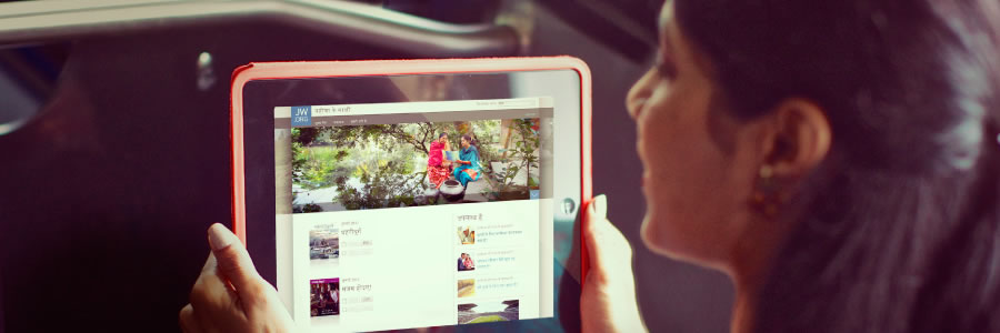 Qadın elektron cihazı vasitəsilə jw.org saytına daxil olur