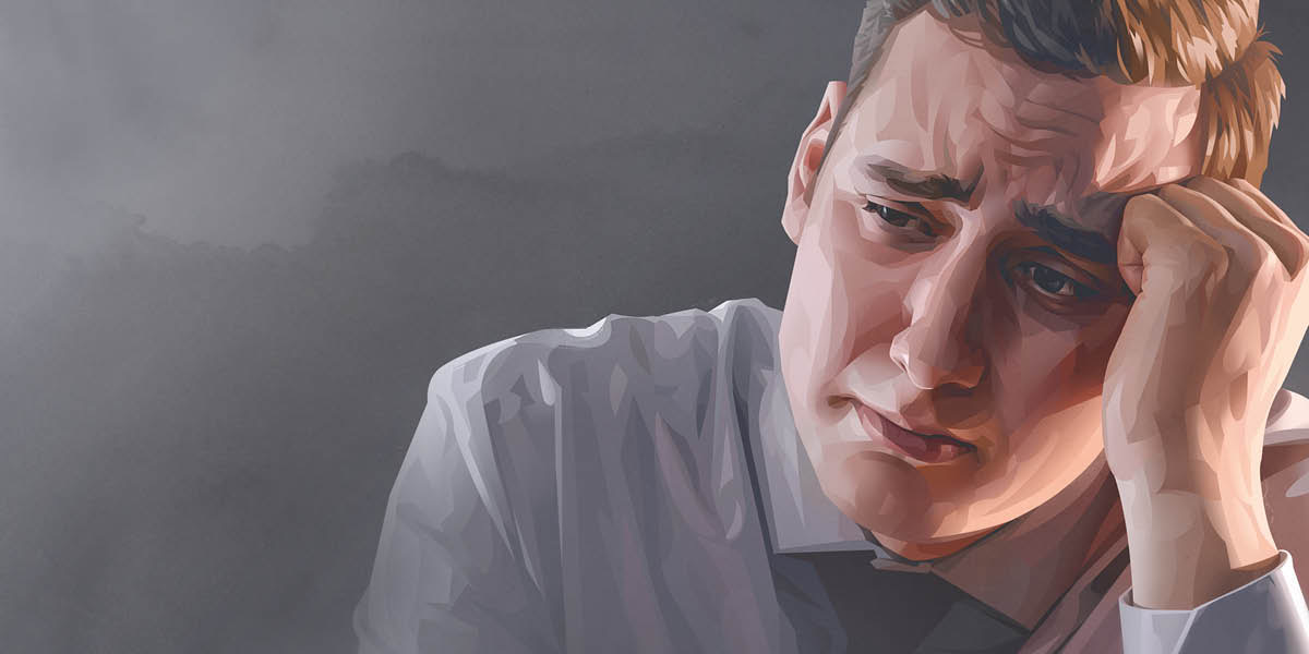 A worried man leaning his head on his hand.