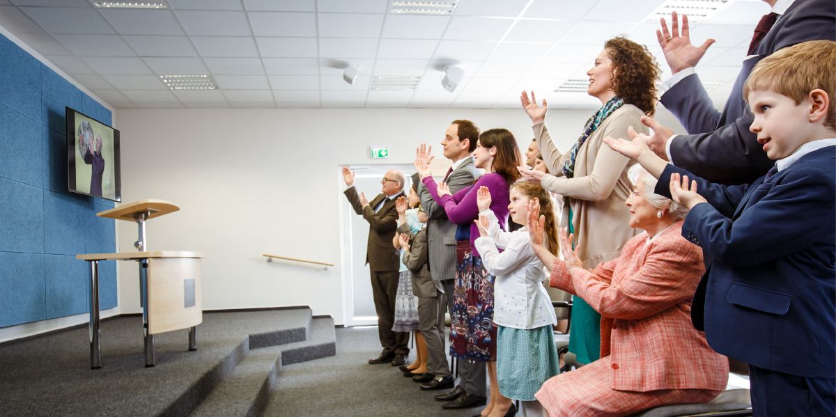 Young and old alike sing at a congregation meeting