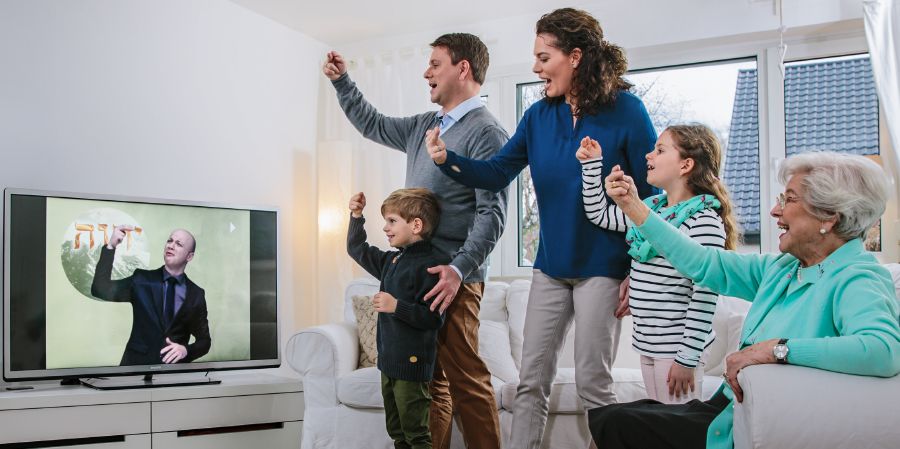 A family practices songs during Family Worship