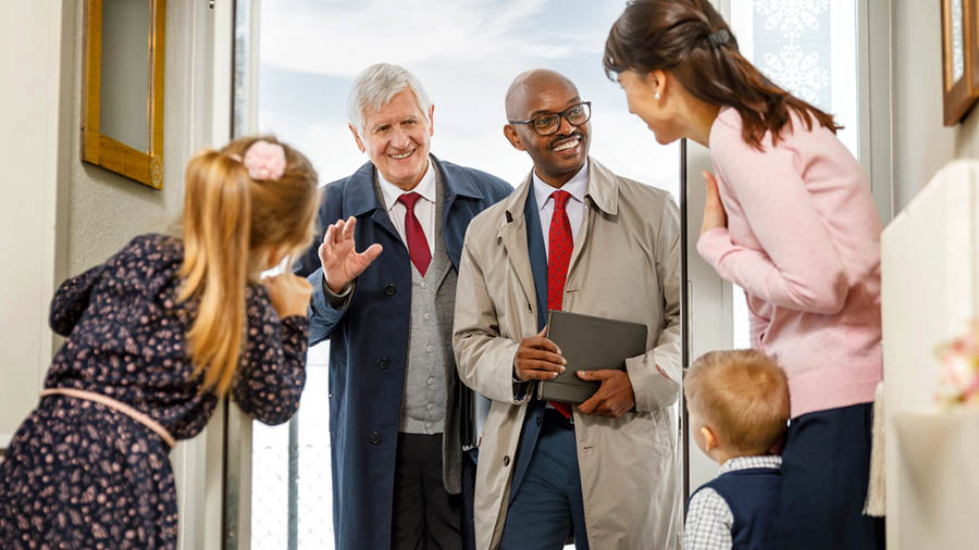 The mother and her children welcoming two elders who have come to their home.