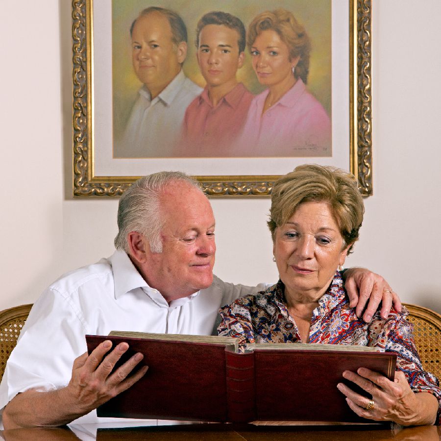 Robert and his wife look at a photo album