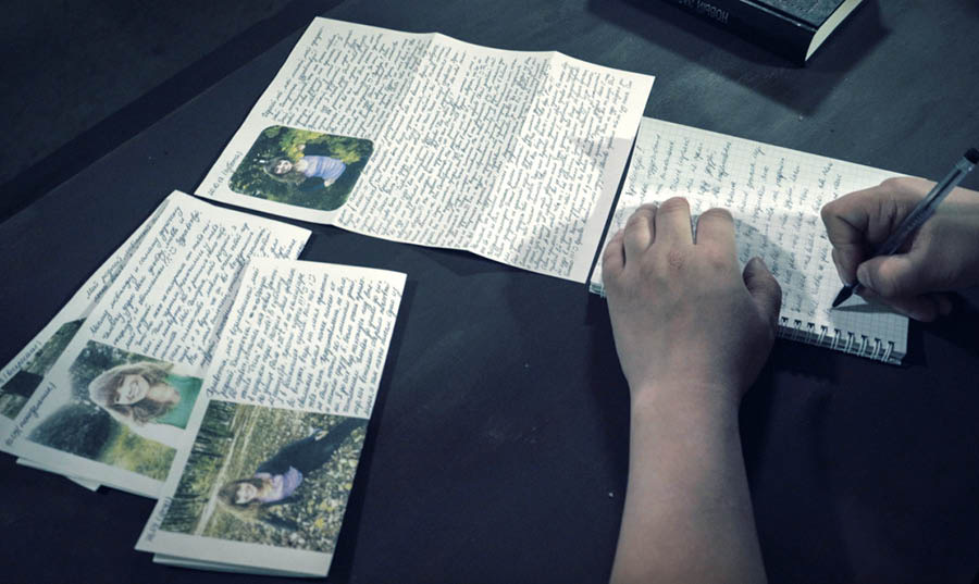 Uma cena do vídeo ‘Entrevista com o Irmão Dmitriy Mikhaylov’. Dmitriy escrevendo uma carta na prisão. Na mesa, há várias cartas da esposa dele.