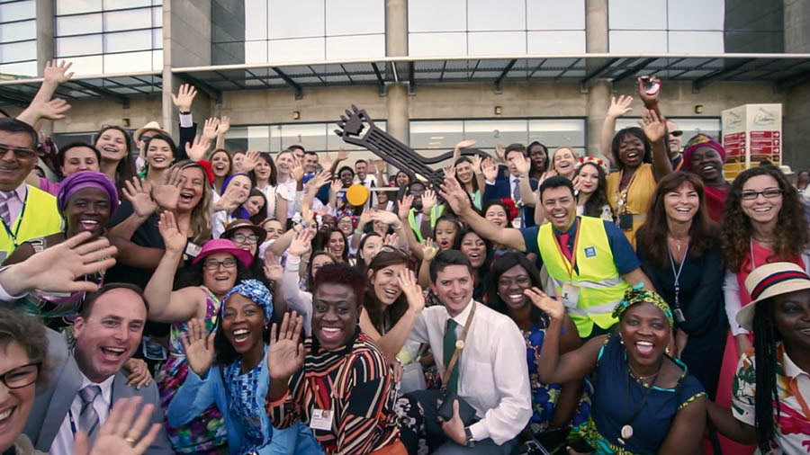 Una escena del vídeo «Assemblees internacions: L’amor mai falla». Germans i germanes locals posen en grup per a una foto amb els delegats visitants.