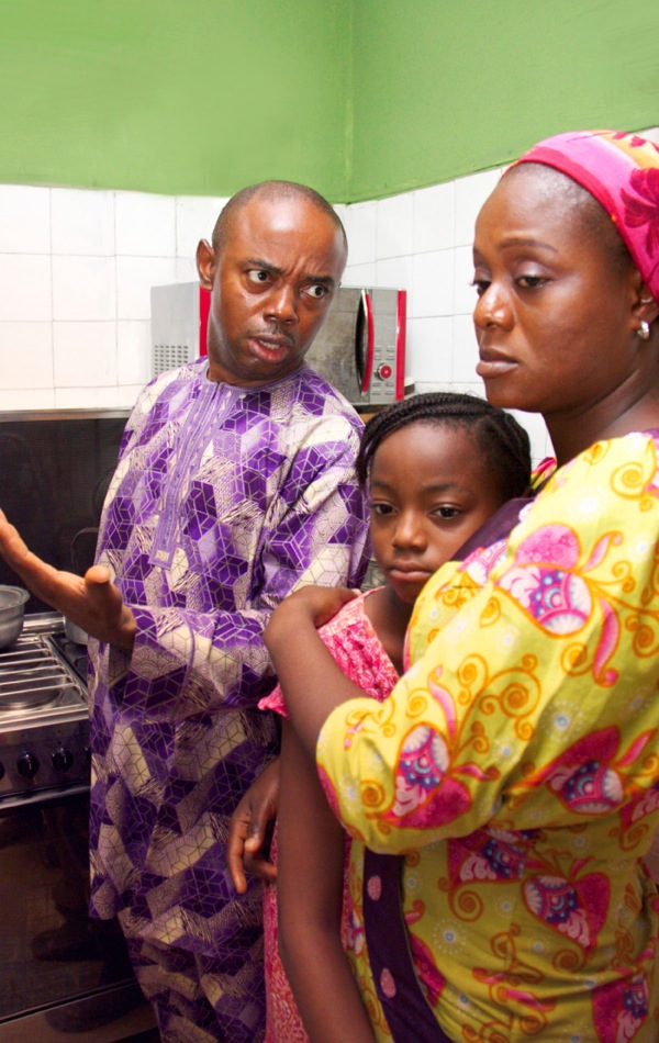 An angry husband scolds his wife and upsets their daughter