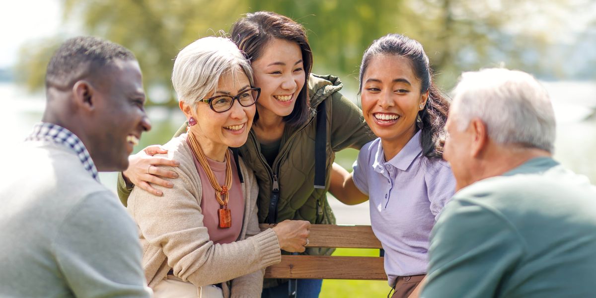 Friends of various ages joyfully spending time together at a park.