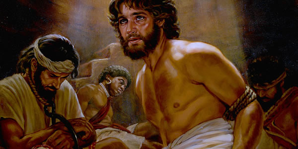 Joseph, bound and in a dungeon, along with other prisoners.