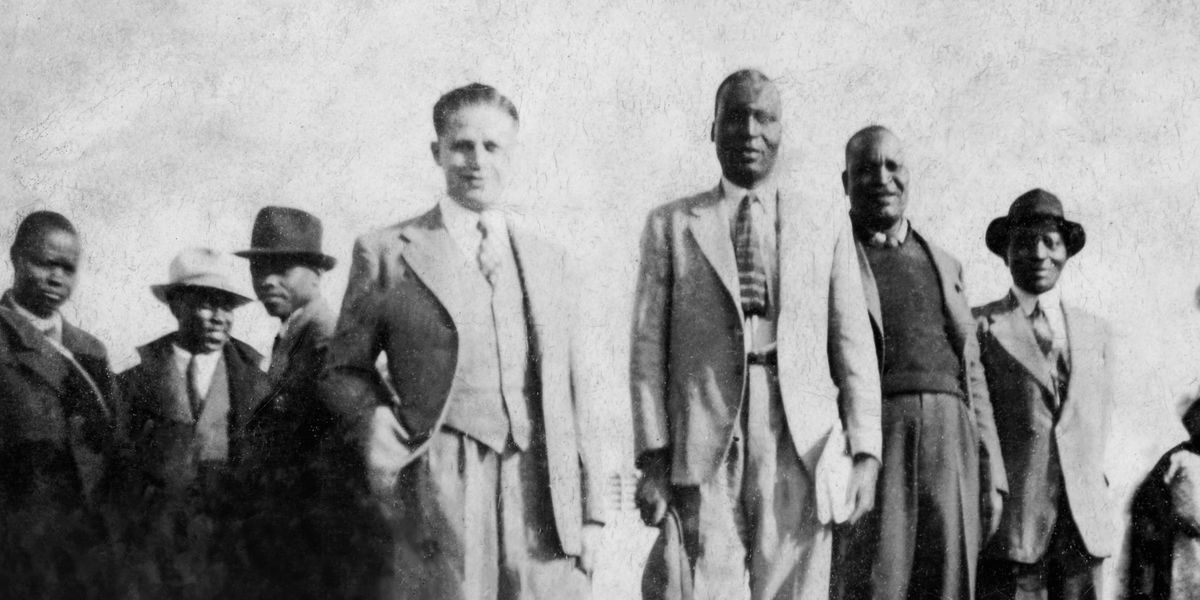 Milton Bartlett and some black brothers preaching in a black neighborhood during the apartheid era.
