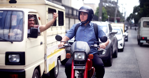 An angry motorist expresses rage as Cassius calmly drives by on his motor bike