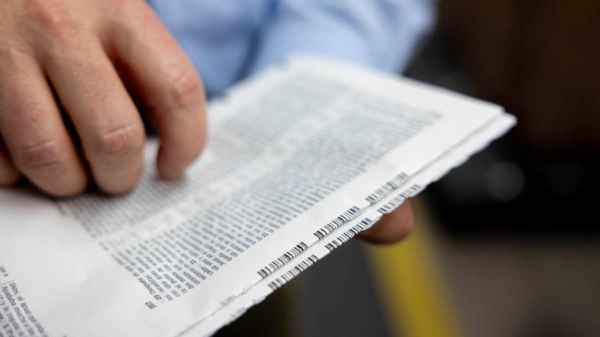 A brother comparing barcodes on two sections of the Bible.