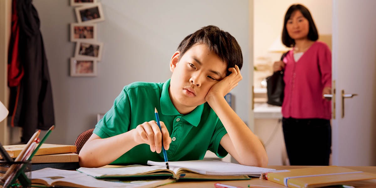 A boy struggles with his homework
