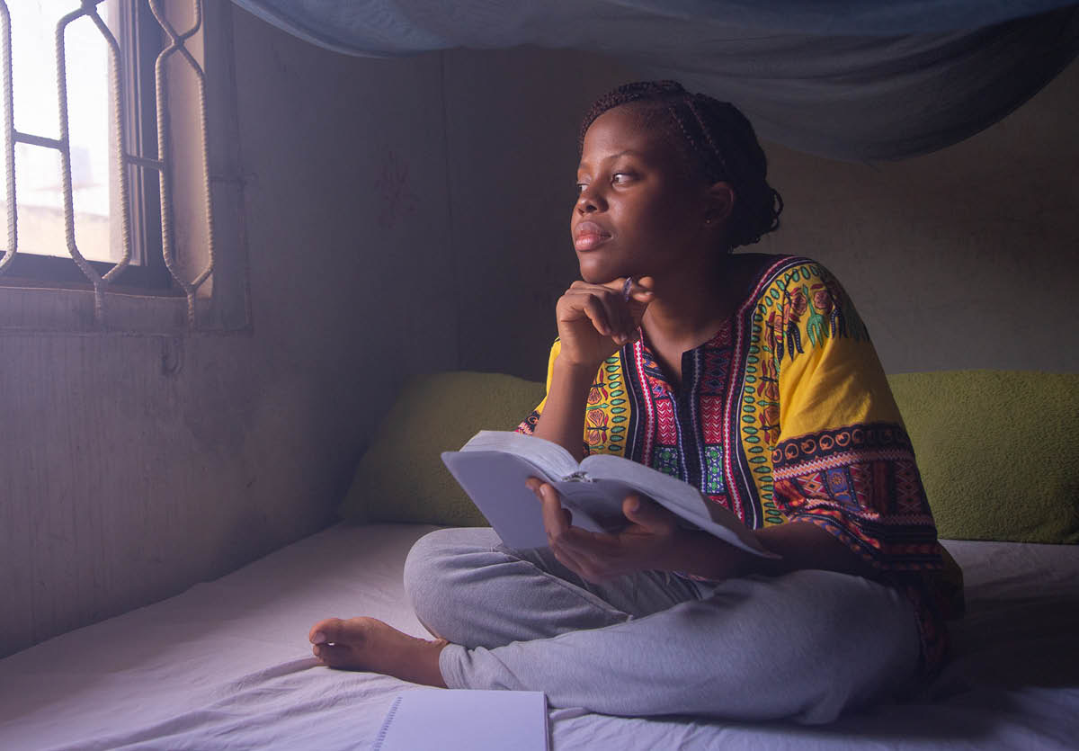 A teenage girl thinking deeply about what she is reading in the Bible.