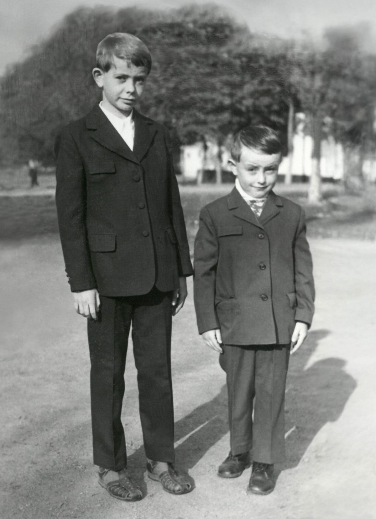 Oleh standing next to his younger brother Mykhailo, during their childhood.
