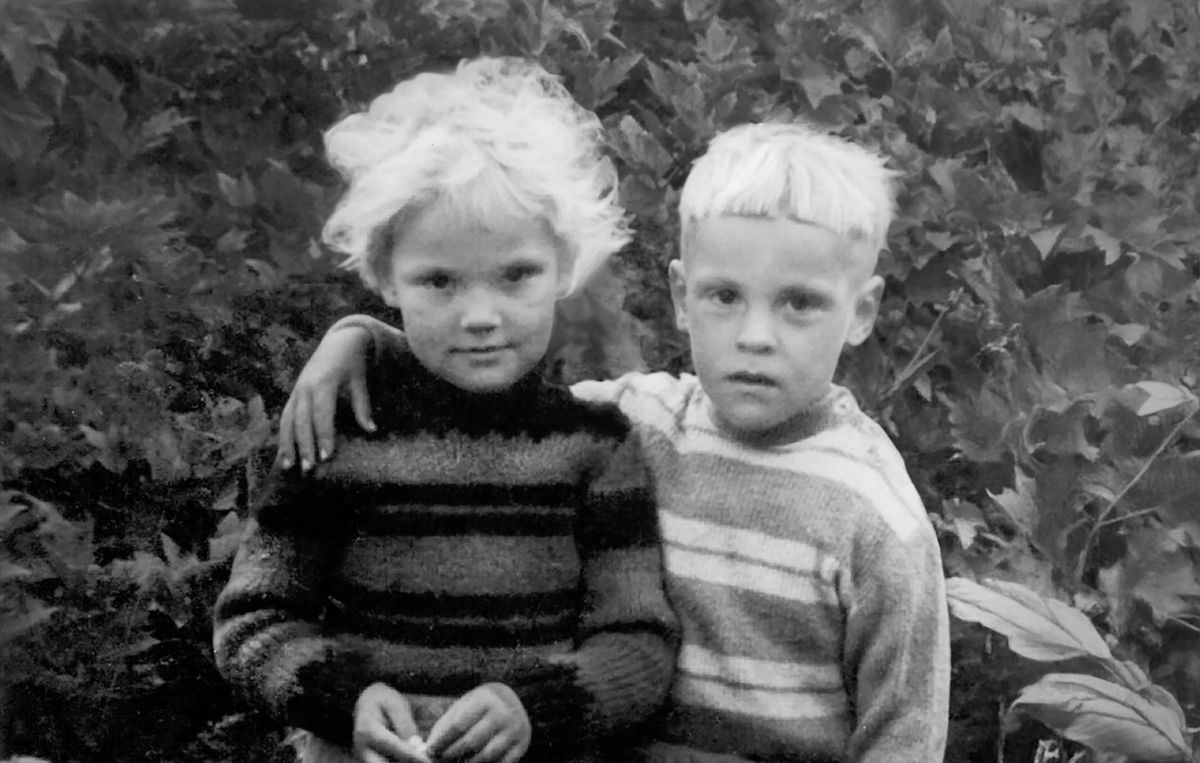 Virgilijus at four years old, standing with his arm around his twin sister, Danguolė.