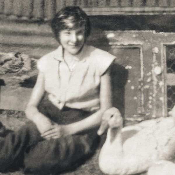 Carol sitting next to a duck.