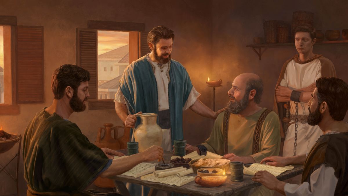 Mark warmly conversing with Paul, who is sitting at a table and chained to a guard. Mark rests his hand on Paul’s shoulder as he brings him something to drink. Two other brothers write and review scrolls.