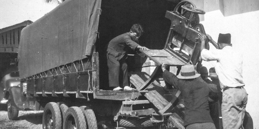 Printing equipment is unloaded from a truck in Jakarta, Indonesia