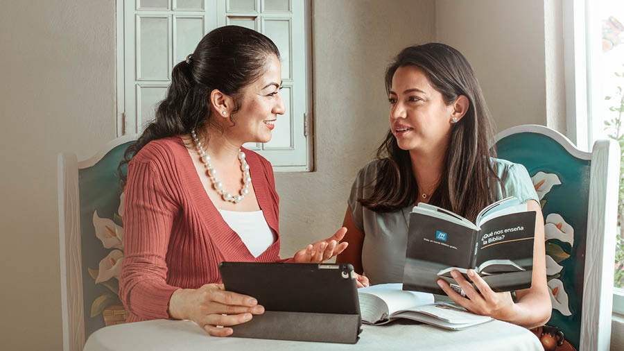 A sister showing her Bible student a video during a study session.