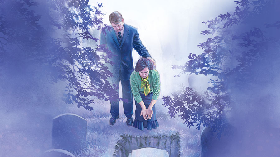 בני זוג בבית קברות בוכים בזמן שהם מסתכלים על ארון המתים שבקבר.‏