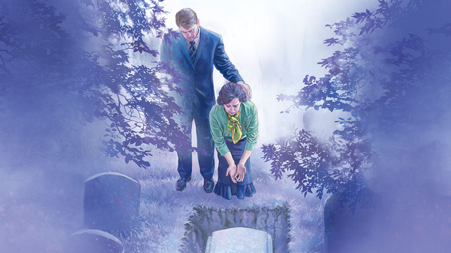 בני זוג בבית קברות בוכים בזמן שהם מסתכלים על ארון המתים שבקבר.‏