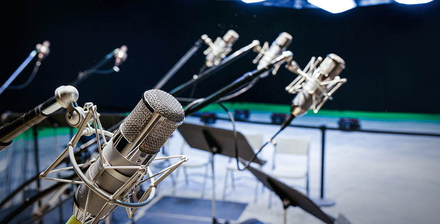 Yan i micrófonos axi kʼwajat al jun estudio de grabación.