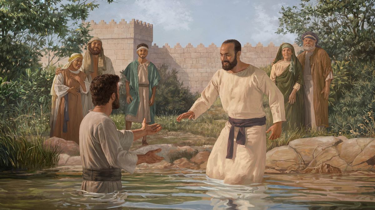 Saul goin into da watta fo get baptize, an some peopo watching.