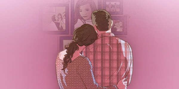 Parents looking at pictures of their young daughter who has died