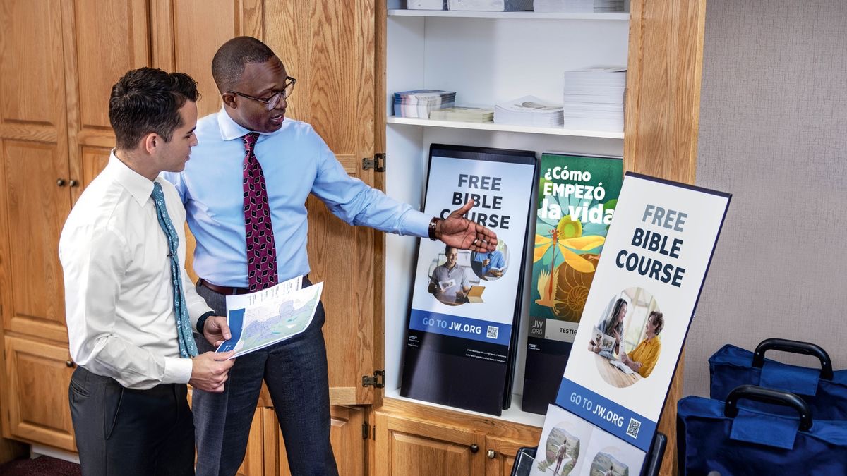 An elder showing a brother where equipment for cart witnessing is stored.