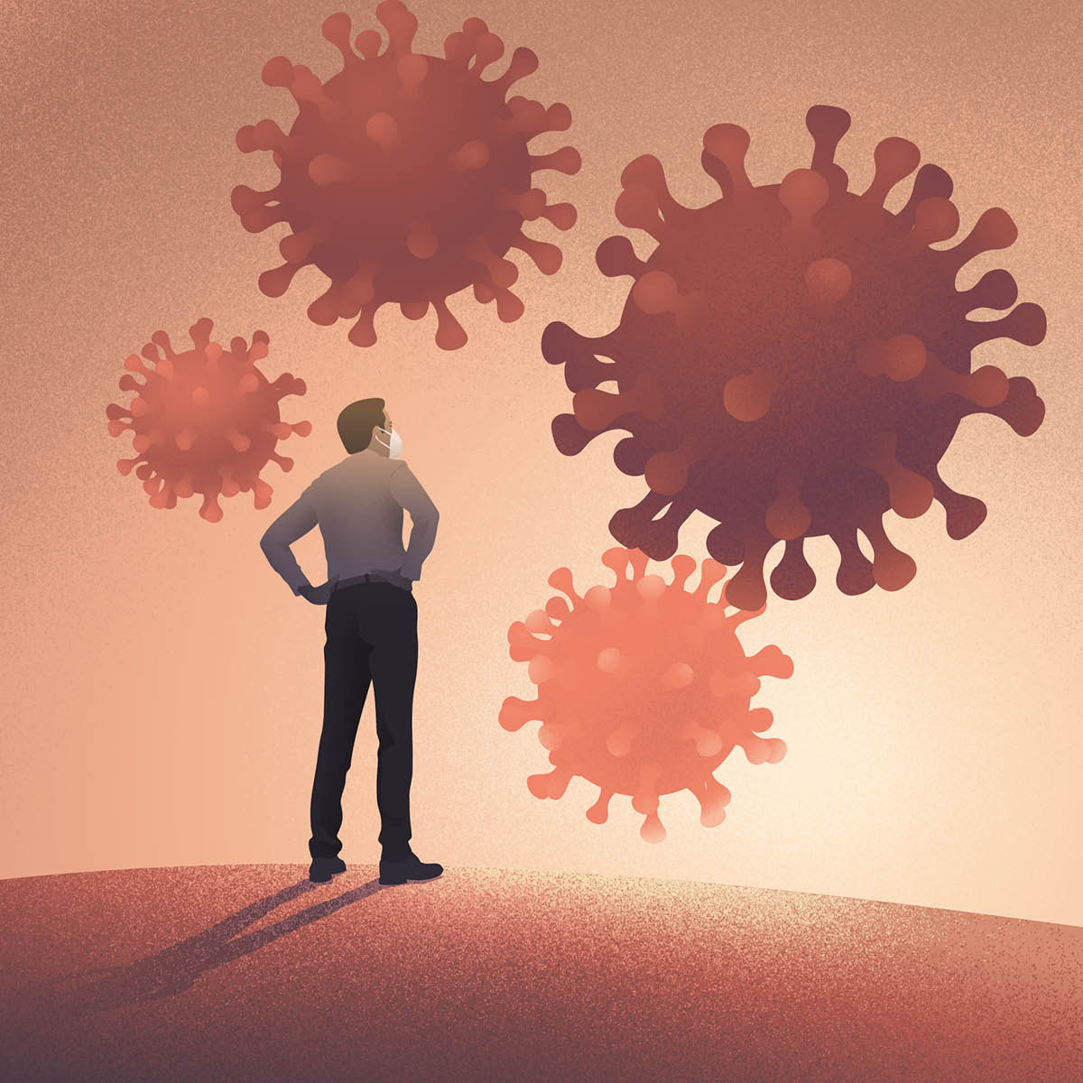 Un uomo guarda immagini ingrandite di coronavirus.