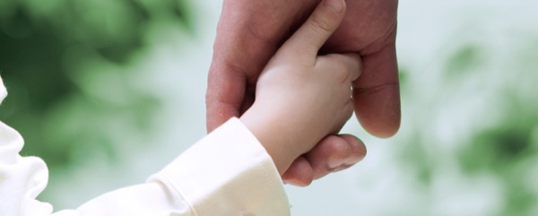 Padre che stringe la manina del suo bambino