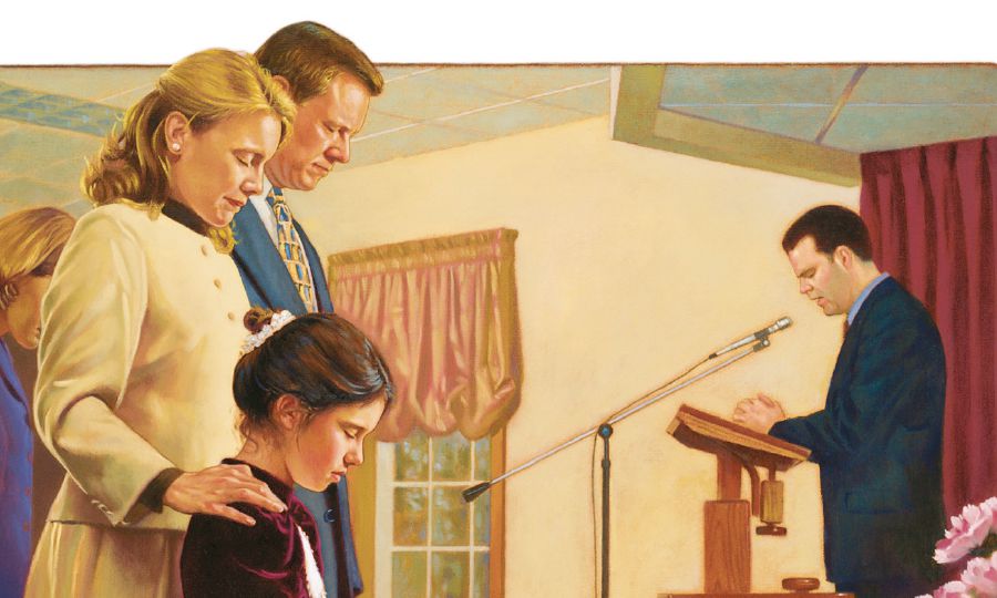 Una famiglia ascolta la preghiera che viene pronunciata a una adunanza