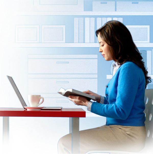 A woman reads her Bible and checks online references