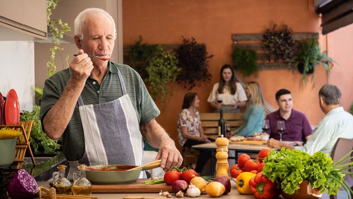 A brother tasting what he has cooked before serving it to his guests.