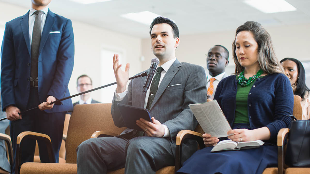 One brother giving comment in meeting.