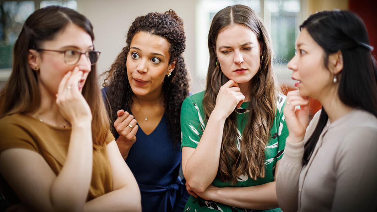 A sister gossiping to other sisters in the congregation. Two of the sisters listen with interest while the other sister reflects on what she is hearing.