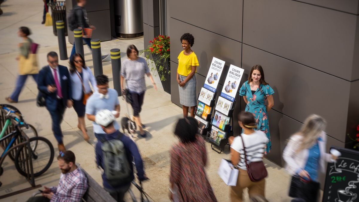 Two sisters doing public witnessing on the sidewalk where plenty people eh. Plenty of them passing by the literature cart without stopping.
