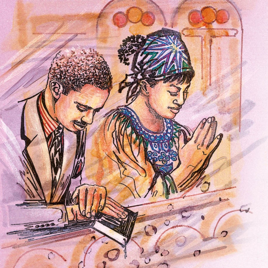 Um casal reza em uma igreja