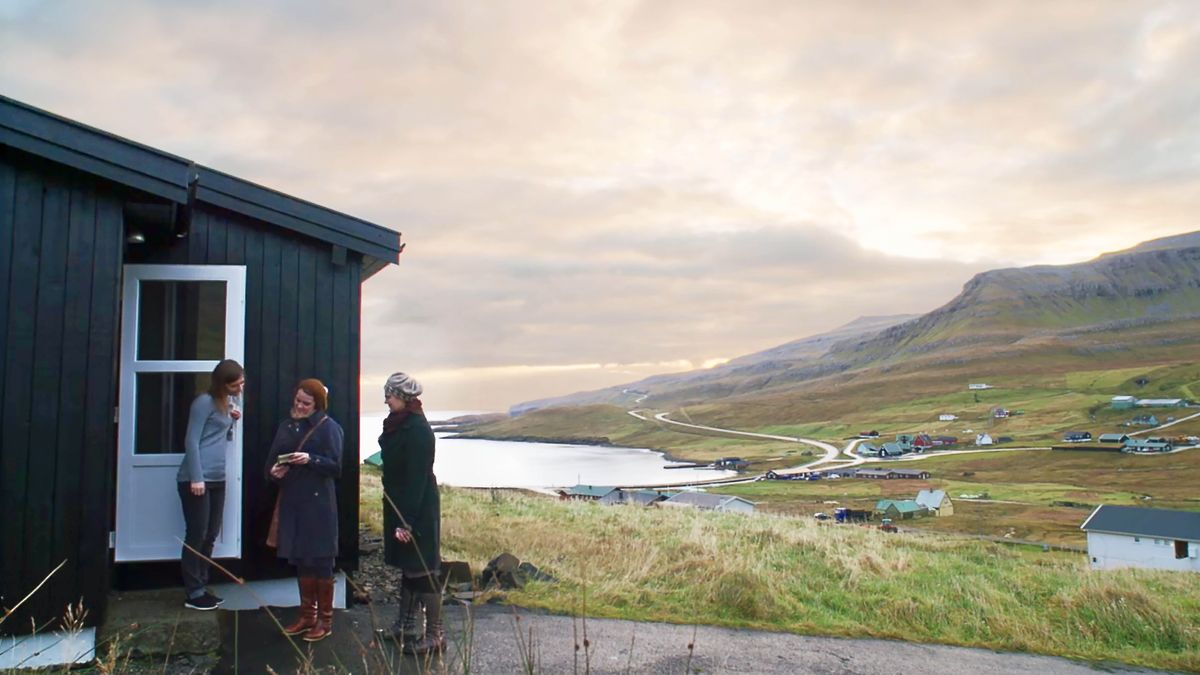 A scene from the video “Preaching in All Weather.” Two sisters preaching to a woman at her doorstep.