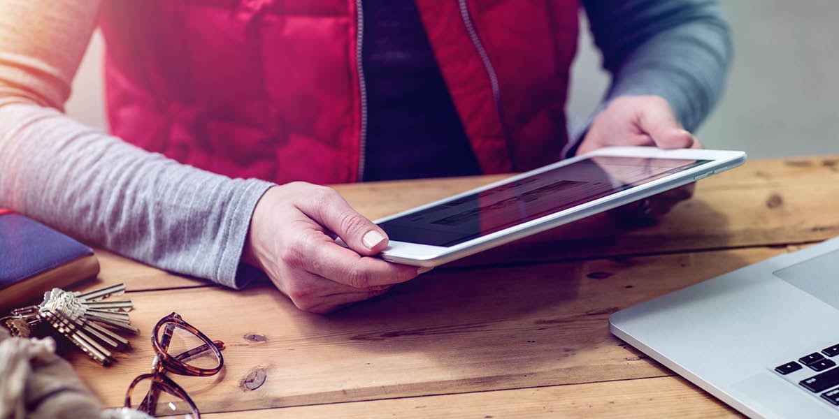 Un hende ta wak jw.org riba un tablet
