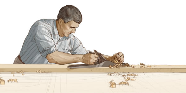 Um homem trabalha arduamente num projeto de carpintaria