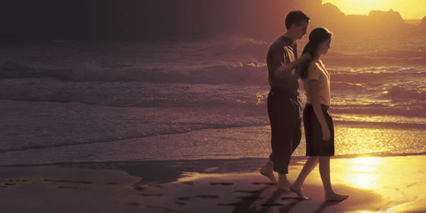 Um casal a andar na praia