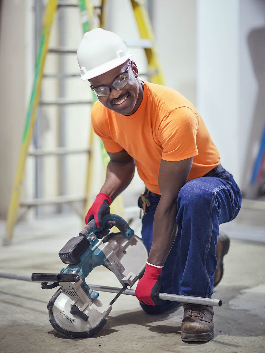 Um irmão trabalhando na construção e sorrindo.