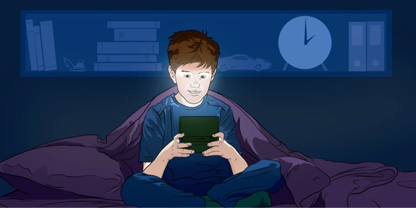 Мальчик в постели играет в видеоигру