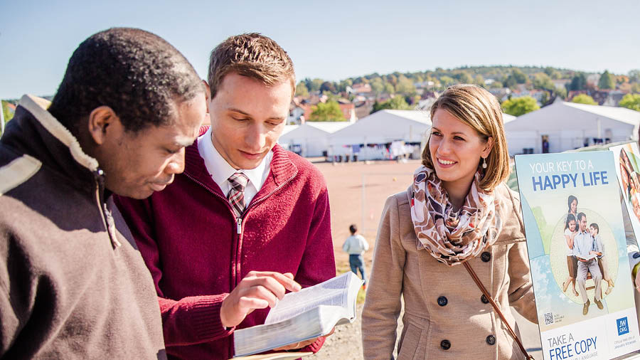 Conjunto de imagens: Maneiras de mostrar imparcialidade. 1. Cinco amigos de idades e raças diferentes comendo e rindo juntos. 2. Um casal pregando para um homem de outra cultura perto de um campo de refugiados.